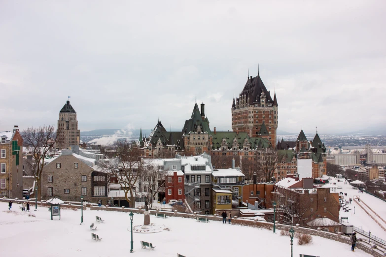 an overview of a city with tall buildings and a snowy field