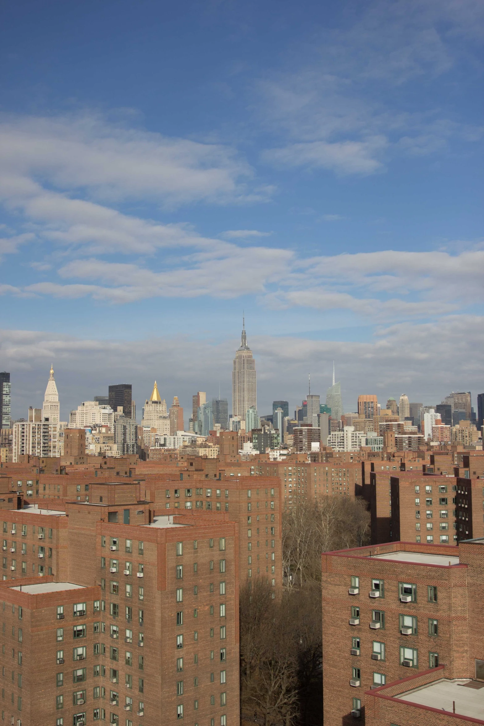 a view of buildings and skyscrs, with one clock tower in the distance