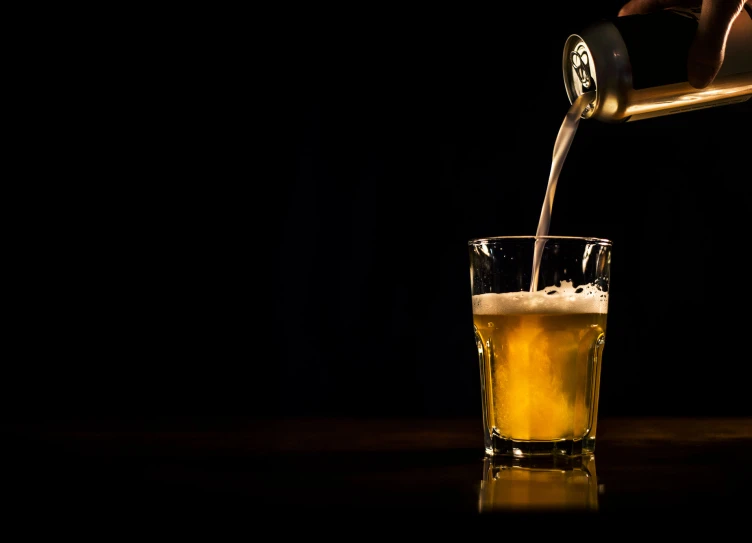 the bartender is pouring an alcoholic drink into a glass