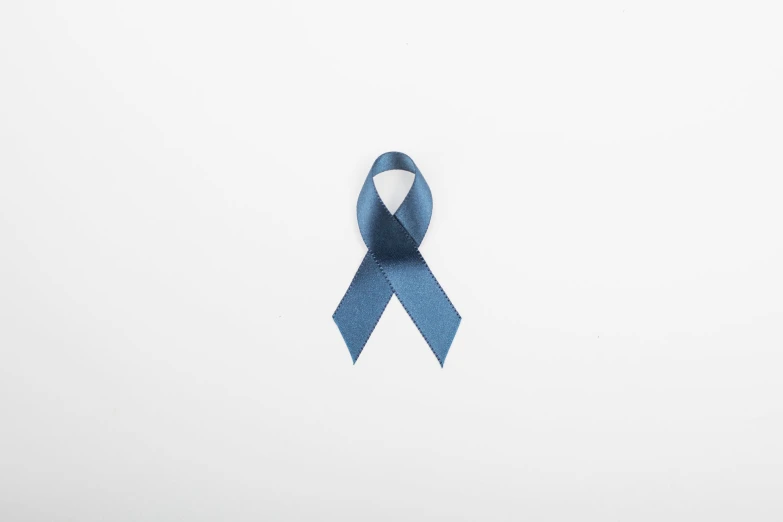 a light blue ribbon laying on top of a white surface