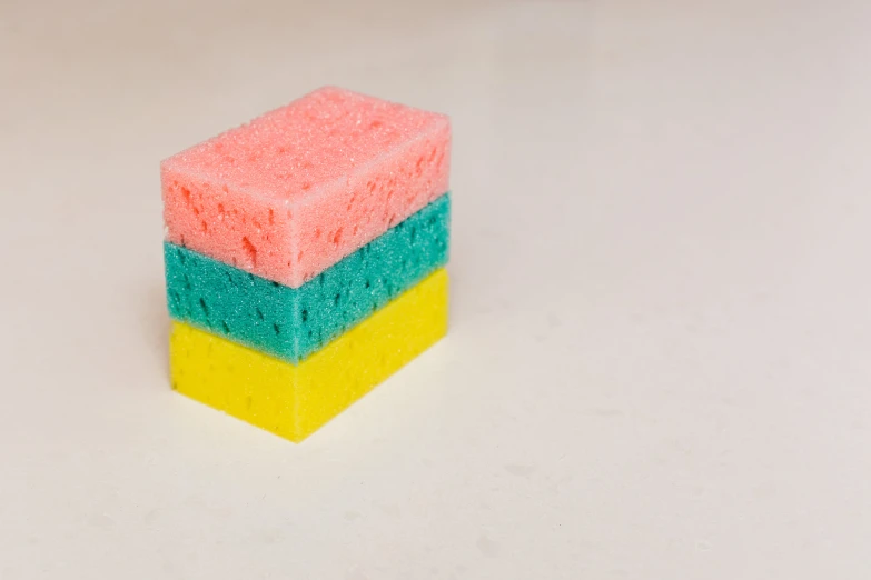 a multicolored sponge on a white surface