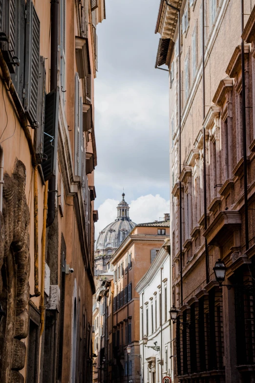 a narrow street with many buildings and lots of window