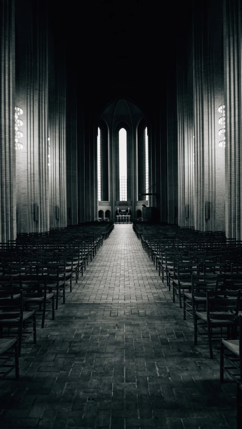 a black and white po with empty chairs in the middle of a room