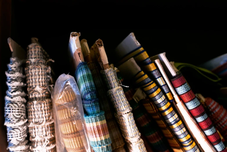 a group of colorful ties sitting on top of each other