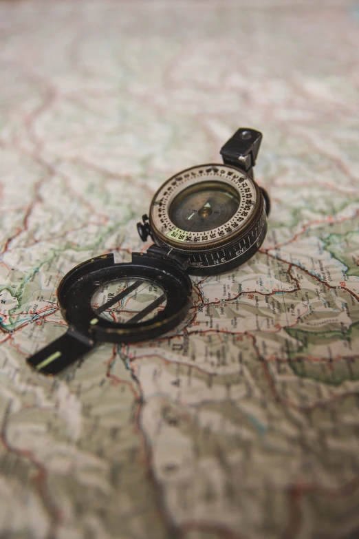 a map with a compass and an cord on it