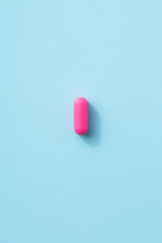 the pills are pink against the bright blue background