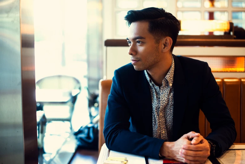 a man sitting at a table with a knife and fork