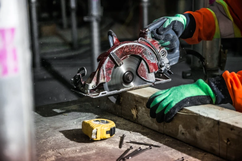 a person using a circular saw to cut wood