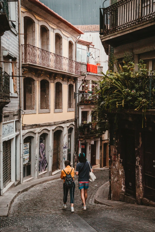 a group of people walking down a stone street