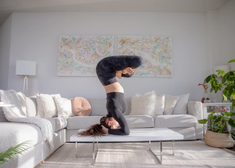 the woman is upside down and performing a backbend