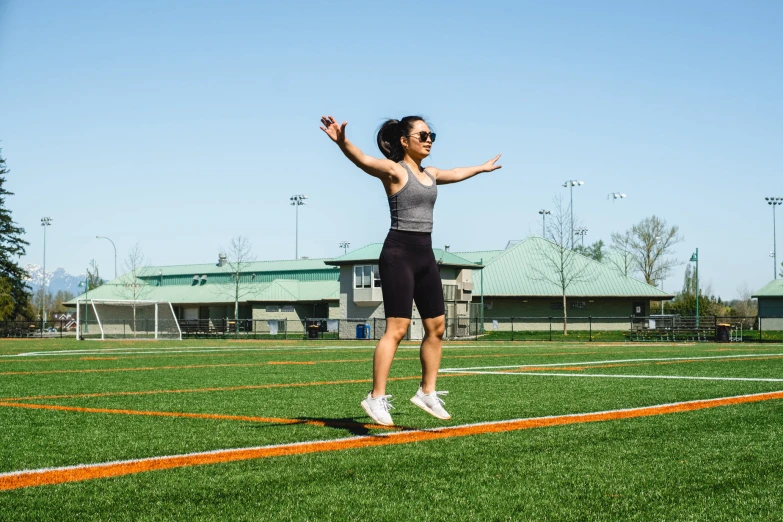 a person jumping in the air on a green grass field