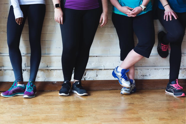 five women standing in a line and posing for the camera