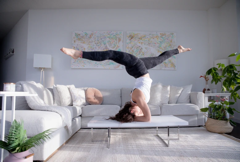 a man that is doing a back hand stand on his stomach