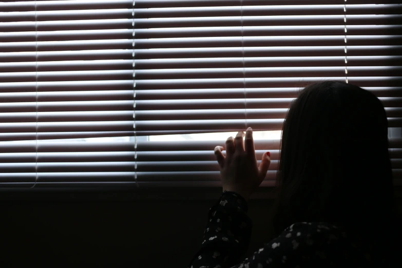 a woman is looking out of a window at soing