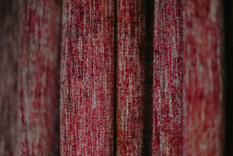 a row of red curtains in a room