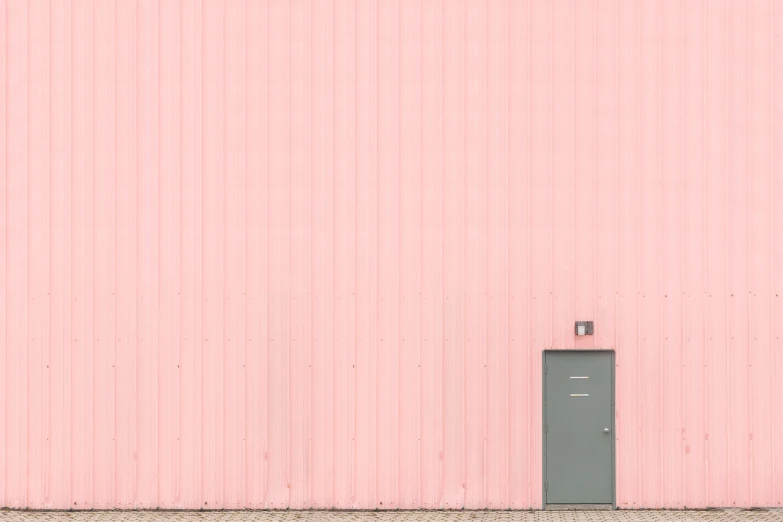 the doors to a pink building with a black top