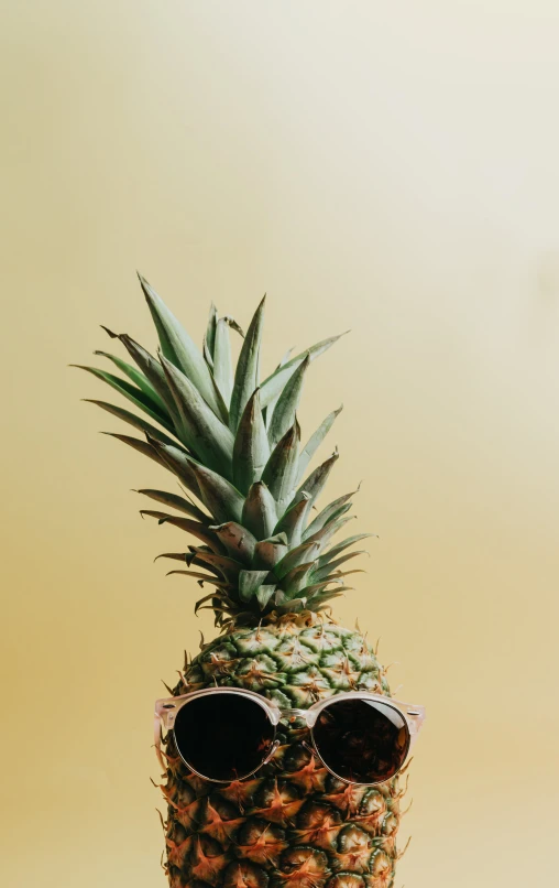 a pineapple with a pair of sunglasses on its face