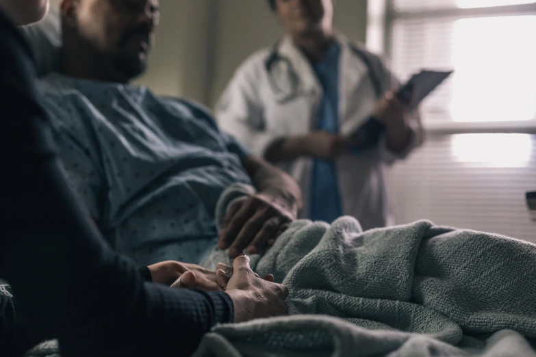 two doctors working on an infant lying in a bed