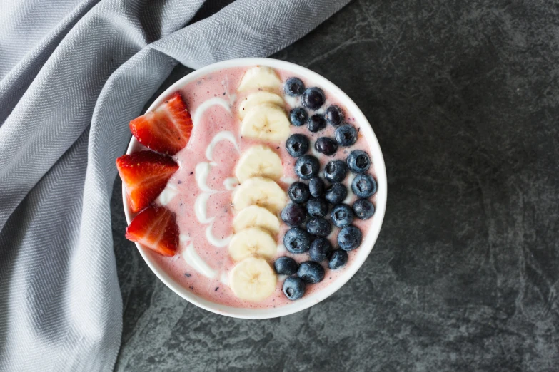 a white bowl filled with fruit and bananas