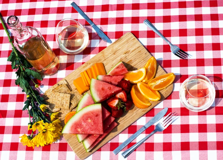 a picnic lunch with watermelon and peach slices