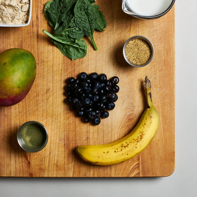 a chopping board covered in different fruits and nuts