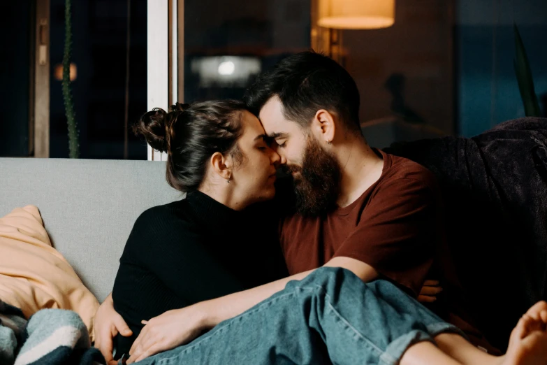 a couple sitting on a couch holding each other