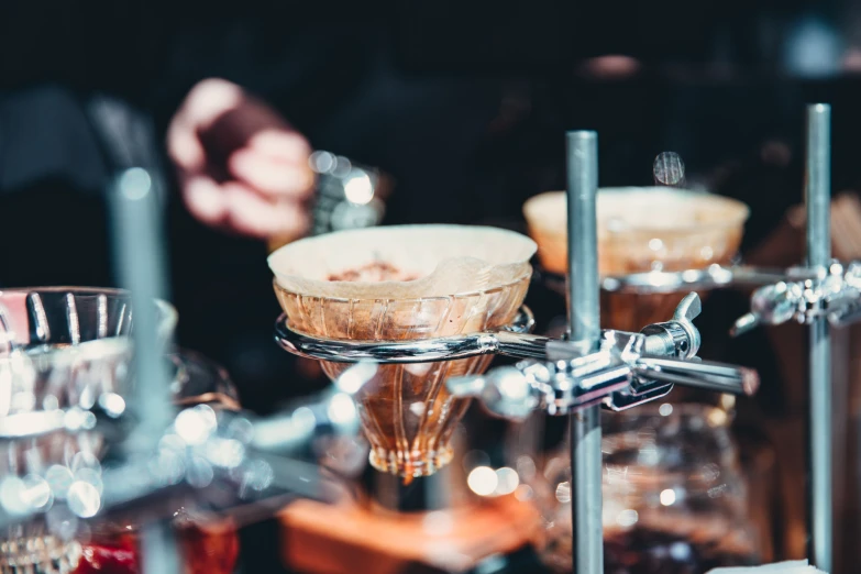 glass containers filled with liquid and sauce on a counter