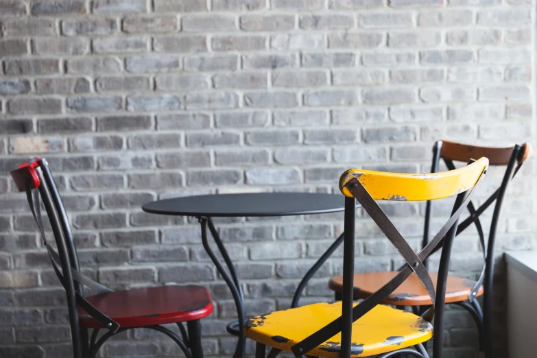 three chairs with yellow seat covers next to each other