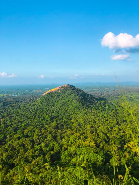 a very scenic view of a large green hill