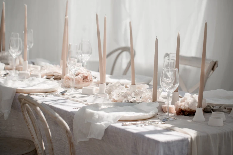 a table with candles and flowers set for a banquet