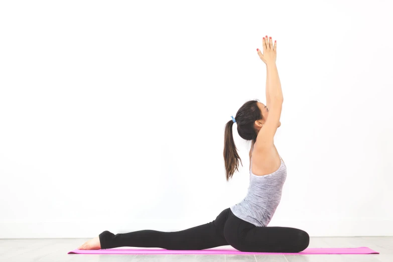 a woman in the middle of a yoga position, stretching