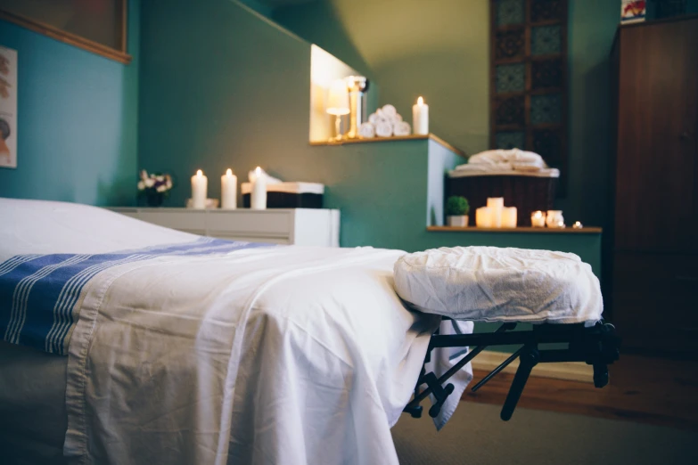 a massage room with candles and a table