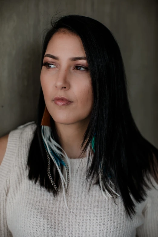 a woman wearing feathers around her neck posing for a po