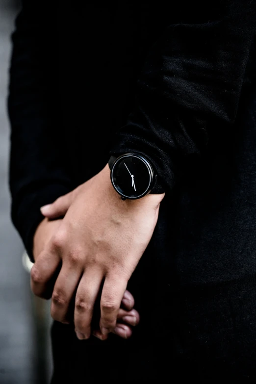 a person wearing a watch with an inscription on their wrist