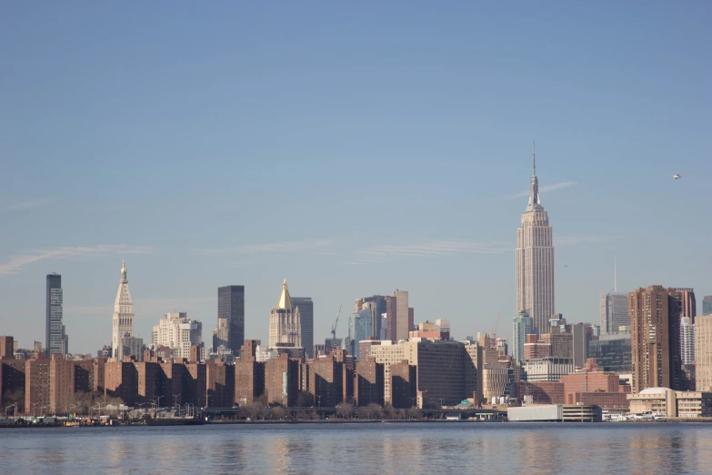 there are buildings and skyscrs along the water