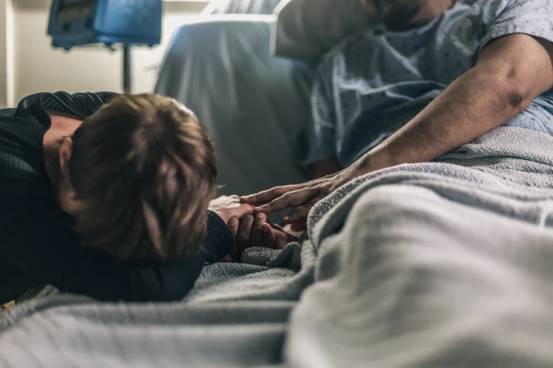 a person laying in bed with an injured hand