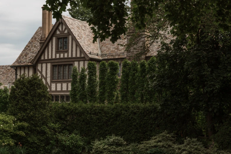 an old style house surrounded by green trees