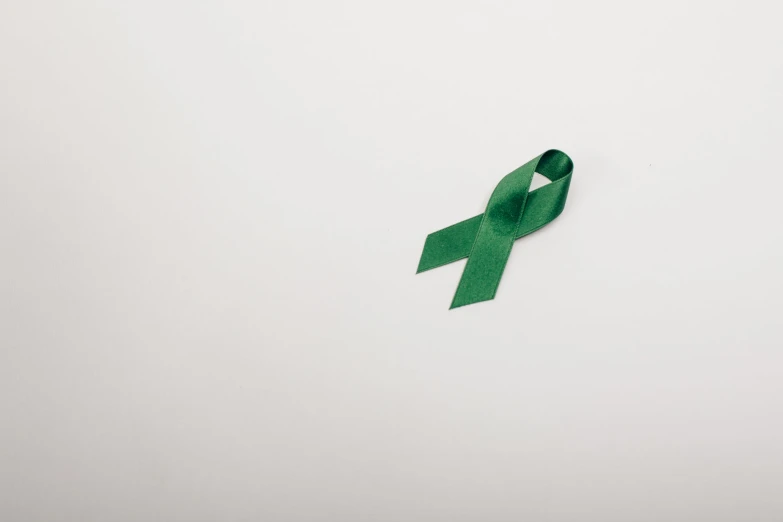 a green ribbon on top of a white table