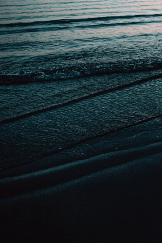 a surfer standing near the water and catching some waves