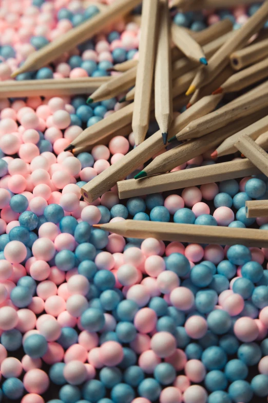 pink, blue and white colored pencils laying on the ground