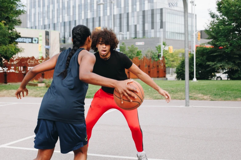 two women are playing basketball with each other