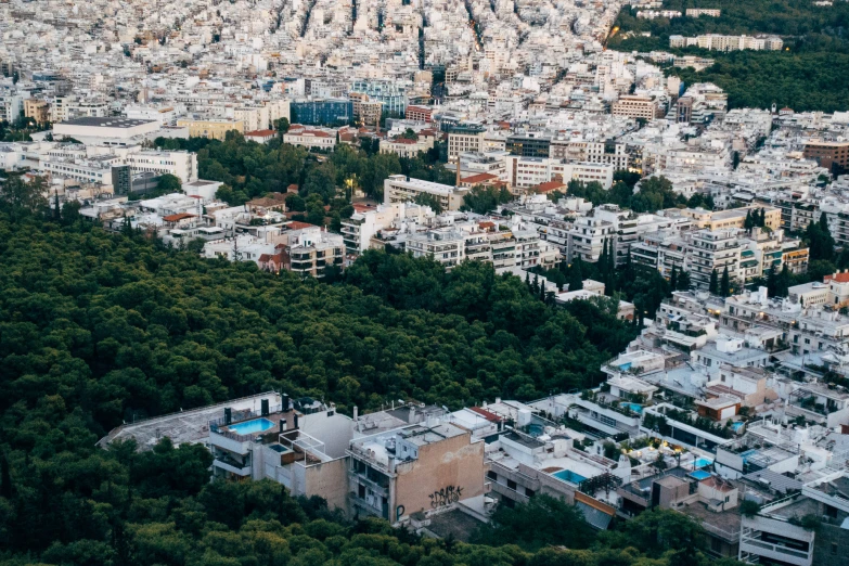 an aerial view of a city area near trees