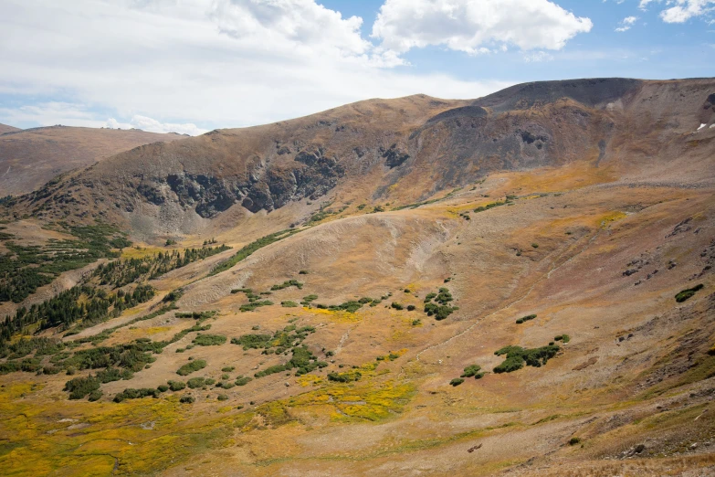 a mountain landscape is seen with brown hills