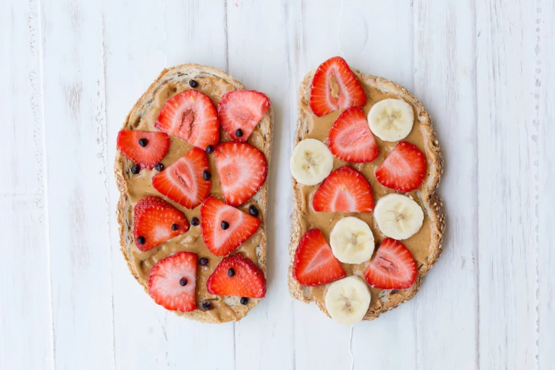 toasted bread topped with peanut er and fresh strawberries