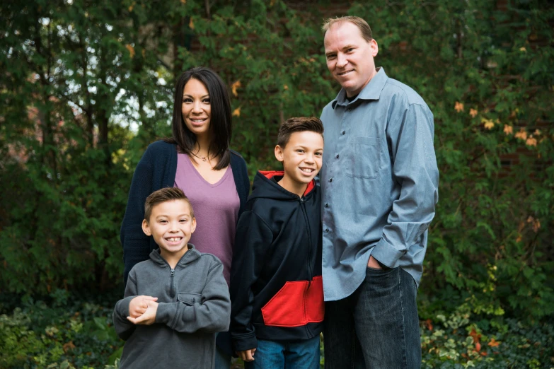 a woman, man and two children posing for a pograph