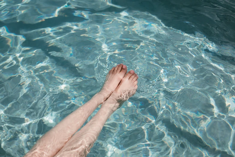 the person is floating in the water near the shoreline