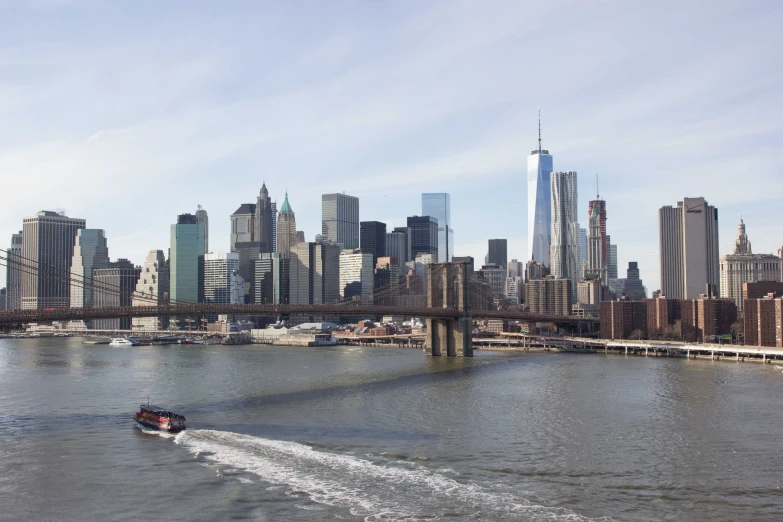 a boat that is in some water near a large city