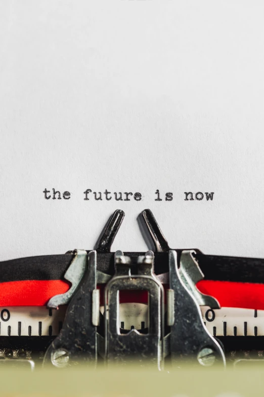 a typewriter with a handwritten text that reads the future is now