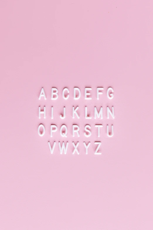 a pink square with a white letter cut out of it