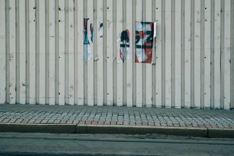 a white building with three stickers on it